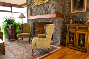 Classic style front living room with a fireplace and two arm chairs.